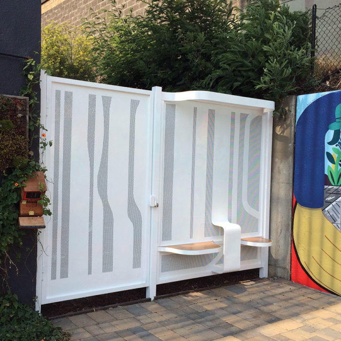 Placemaking installation at Burrows Street Pocket Park in San Francisco, featuring CNC laser-cut steel gate and custom stainless steel benches fabricated by Engineered Artworks in collaboration with Rebar Design Studio.