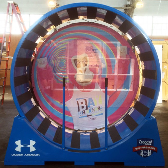 Custom-fabricated human hamster wheel by Engineered Artworks — kinetic sculpture built for events and brand activations, with modular design and lighting; available for commission.