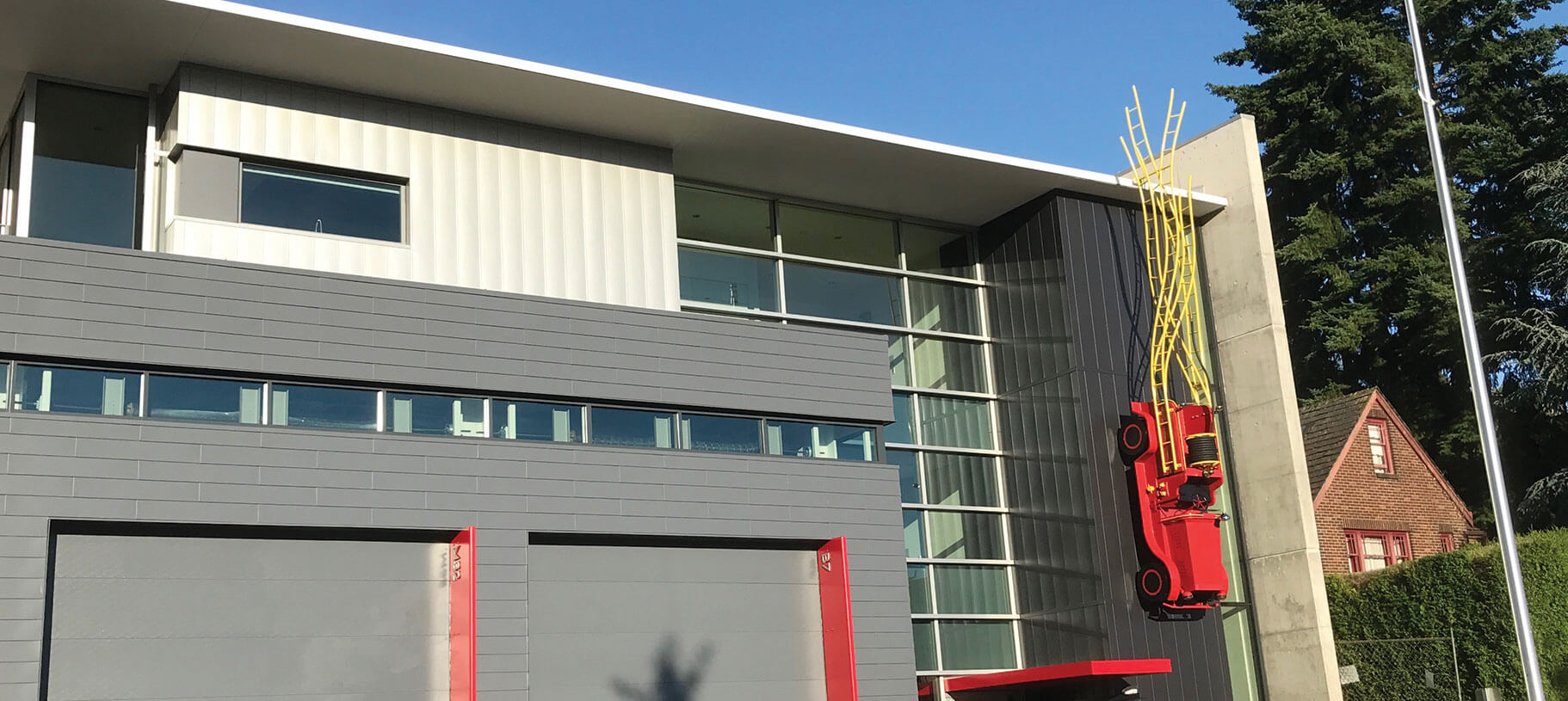 Public sculpture Engine 32 ½ fabricated in painted steel and aluminum by Engineered Artworks for Seattle Fire Station 32 renovation