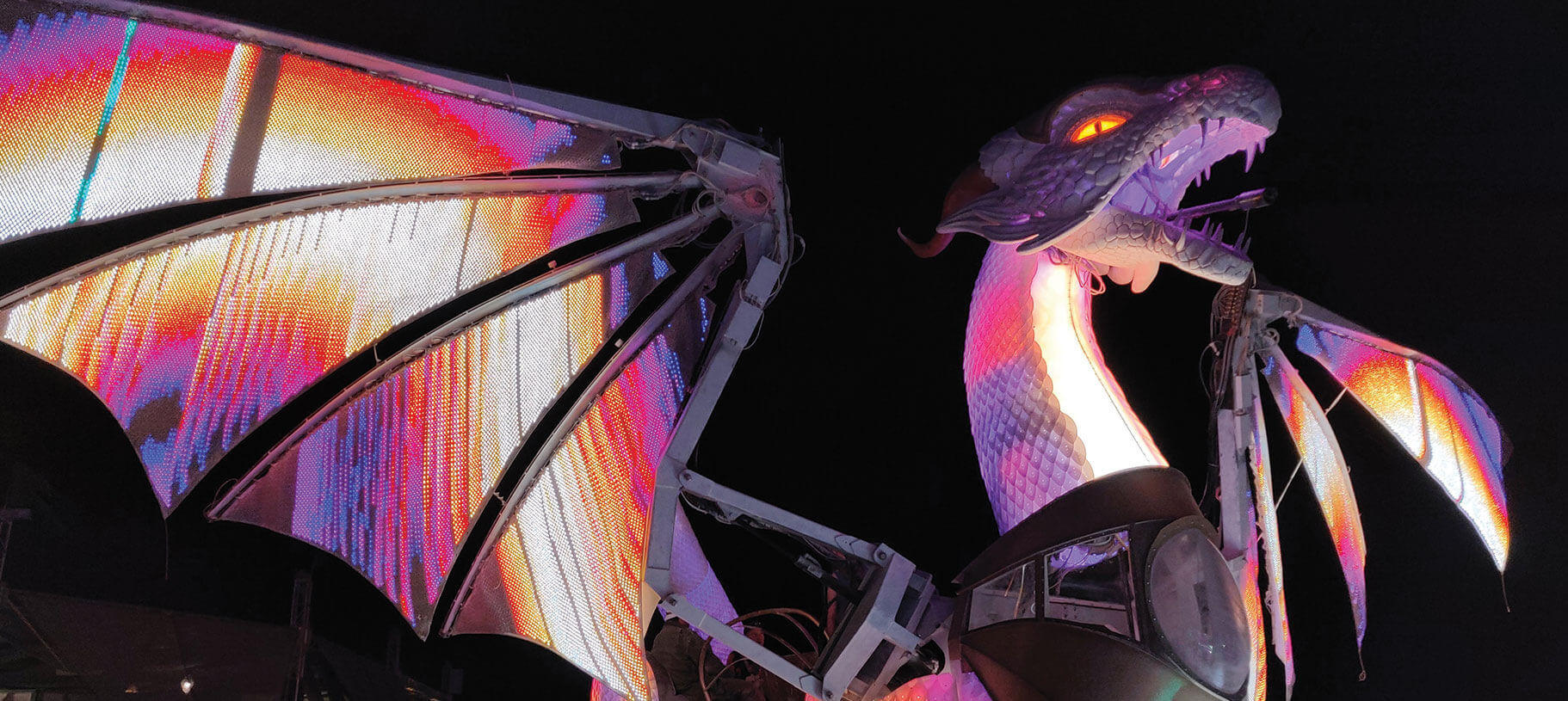 Kinetic metal dragon sculpture with programmable LEDs and hydraulic wings fabricated by Engineered Artworks