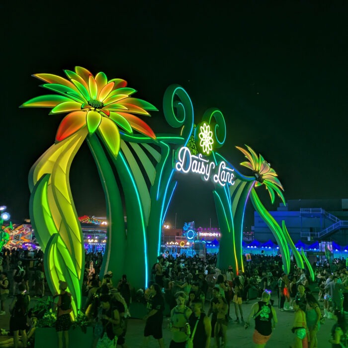 Daisy Lane Portal large-scale festival installation at Electric Daisy Carnival featuring illuminated floral arch structure with LED lighting in Las Vegas